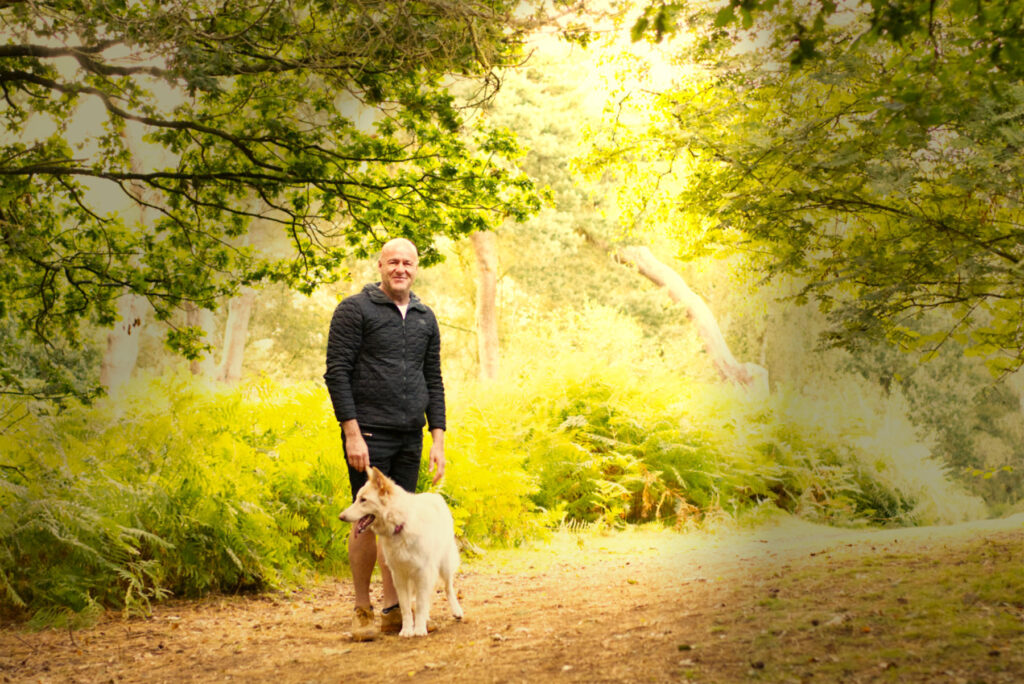 White German Shepherd GSD with male owner in wood bathed in evening sunlight by Photography by Nadina Bee BEE_5651